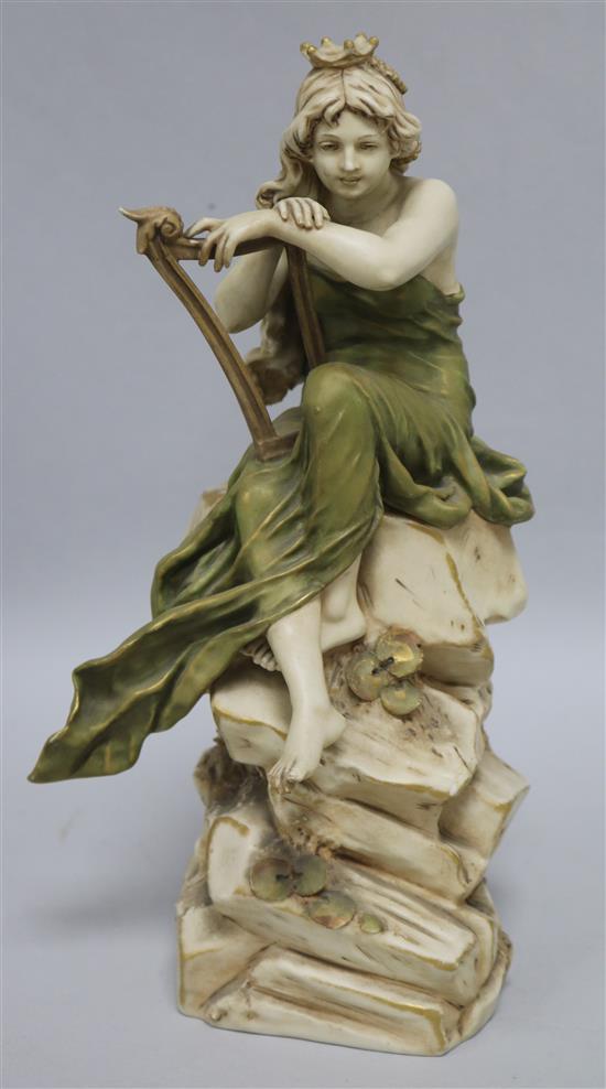 A Royal Dux figure of a girl sitting on a rock